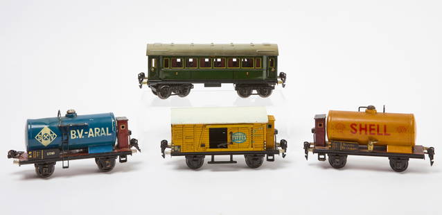Four Marklin Train Cars - Kesselwagen and Others: Four Marklin train cars. First, a covered passenger car &#39;2&#39; with hinged top. A 17740 BV-ARAL Kesselwagen, A Shell Kesselwagen 17740. Finally, A Jamaica banana car. Germany, early 20th century.