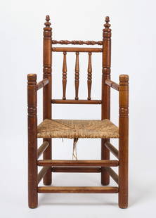 Carver Armchair: Carver armchair with elaborate turnings and incisions. Circa 1920. H 47 in. W 24-1/2 in. D 18 in. Condition: Minor surface imperfections. Old split to inside of sitter&#39;s back right leg. Link to hi