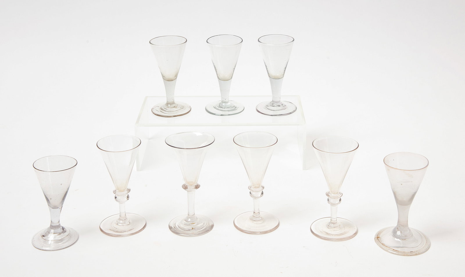 Nine Early Blown Glass Wine Glasses: Nine early blown glass wine glasses. American, 18th century. H each range 4 in - 4-1/2 in. Condition: No damage noted. Link to high-res images: https://www.dropbox.com/scl/fo/xwqn8e3skj4ivkyx8d1fx/ADI