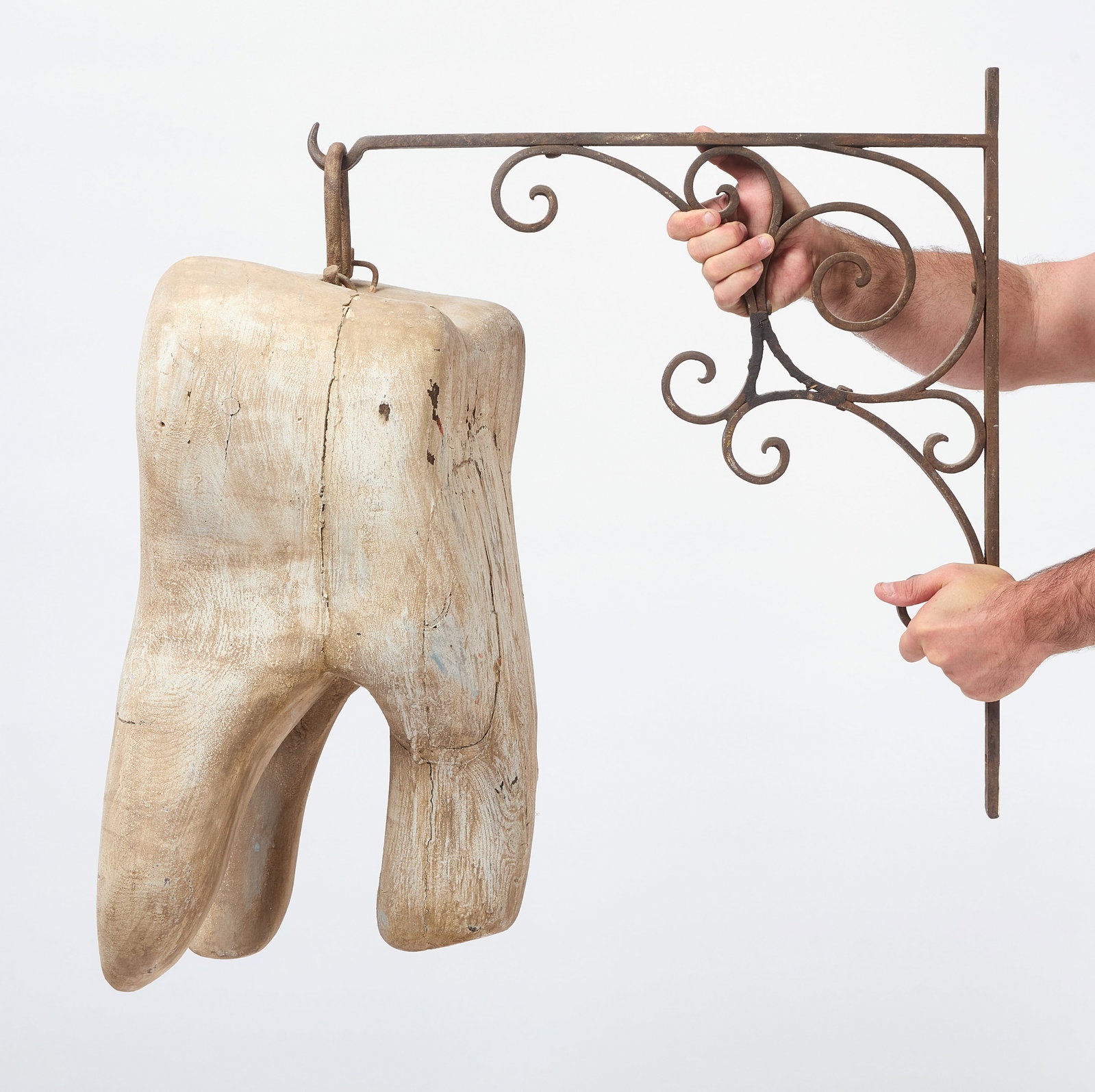 Early Dentist Trade Sign: Early dentist trade sign in the form of a tooth. Carved wood with white paint. Period hanging bracket included. American, circa 1880. Tooth: H 21-3/4 in. W 14 in. D 11-1/2 in. Bracket: H 22-3/4 i