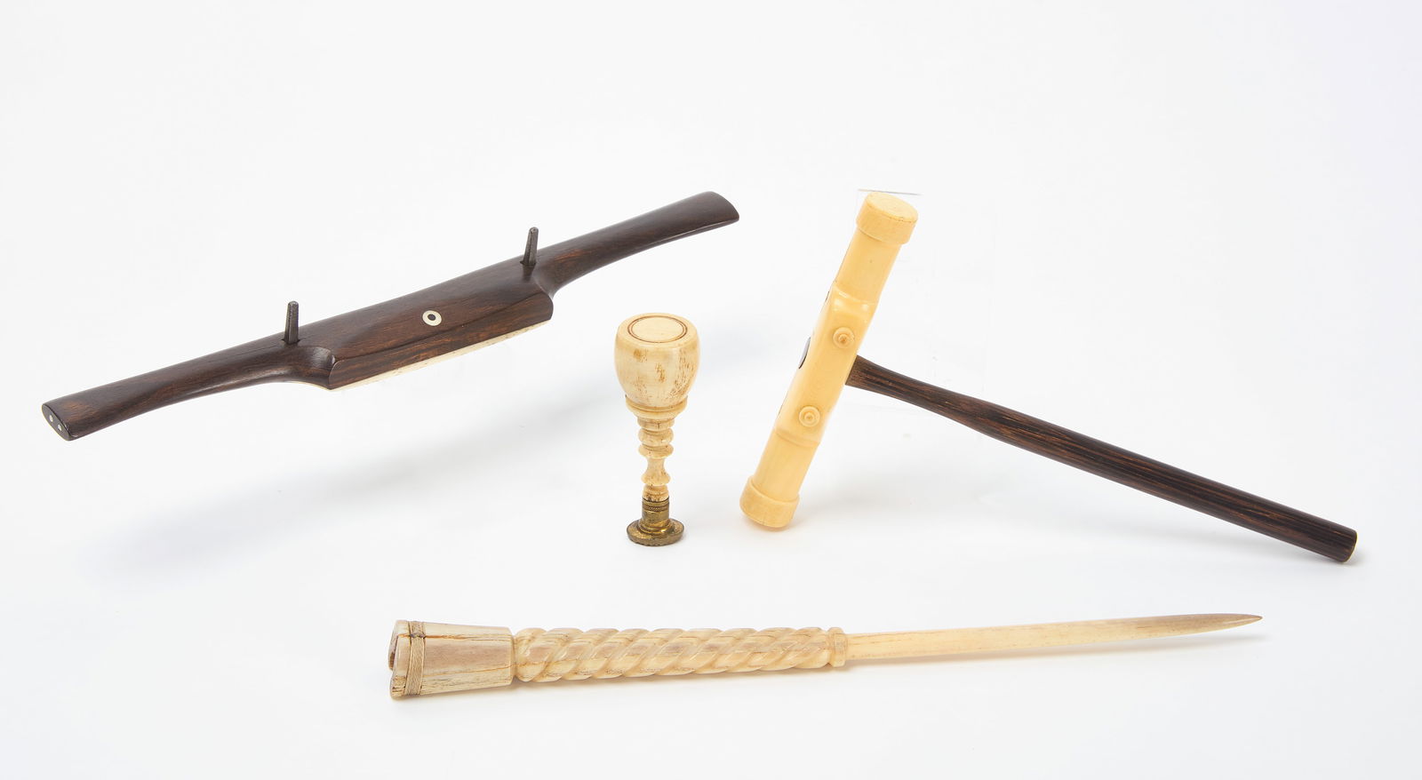 Four Sailor's Tools: Group of four antique sailor's tools. Several with bone components. New England, late 19th century. Hammer: L 8 in. W 5 in. Clamp: L 11-1/8 in. Fid: L 11-1/2 in. Stamp: H 3-1/4 in. Link to h