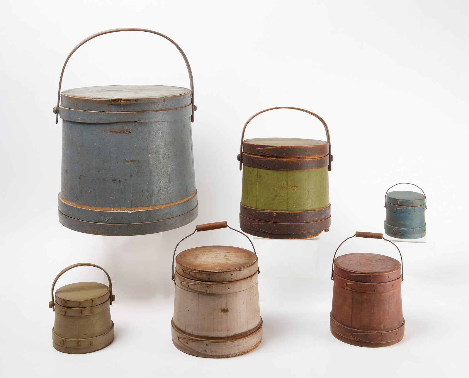 Six Painted Firkins: Six painted and handled firkins. American, 19th cenutry. Dimensions do not include the height of the handle. Diameter taken at lid. H 4-3/8 in. D 4-1/8 in. H 4-3/4 in. D 4-7/8 in. H 7 in. D 6-1/4 in.