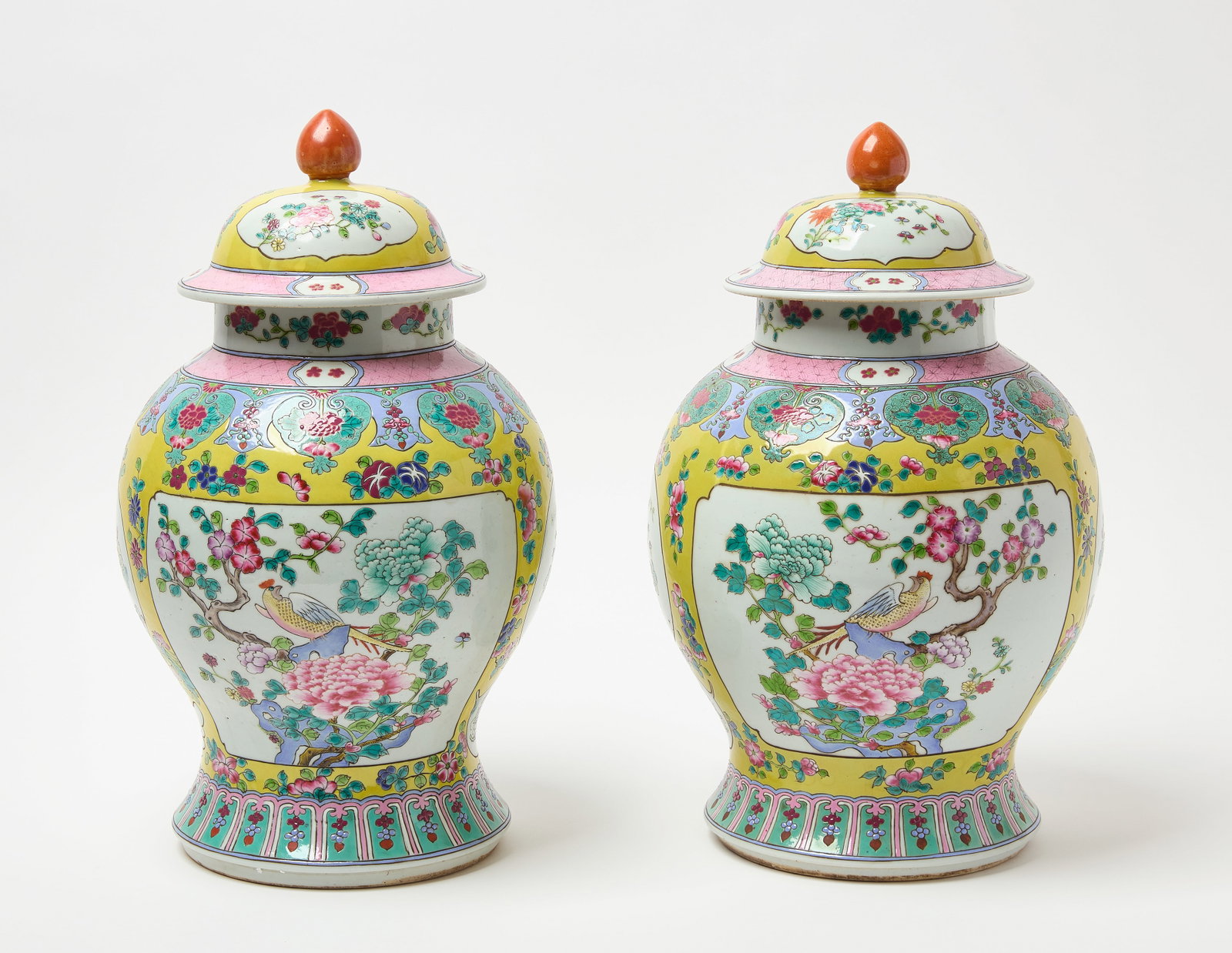 Pair of Chinese Famille Rose Porcelain Jugs: Pair of Famille Rose porcelain jugs with lids. Floral images with small intricate birds. Brightly colored in yellows, blues, and pinks. Chinese, Qing Dynasty (19th century). H 17-1/2 in. W 