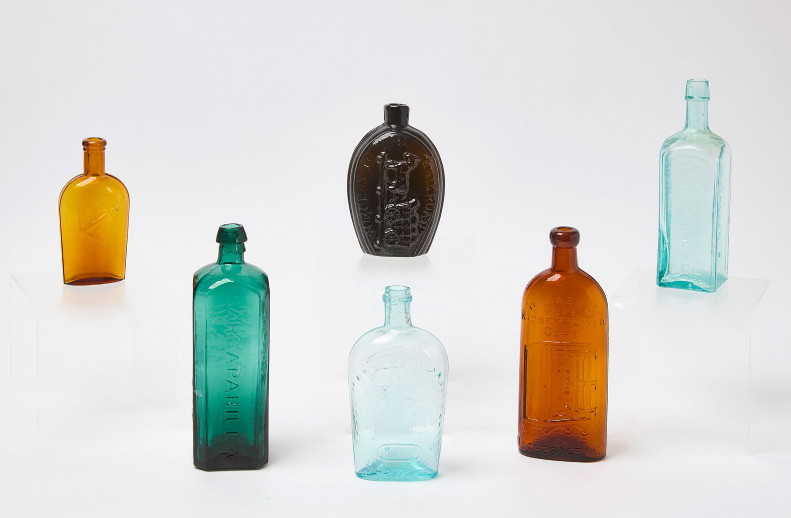 Group of Historical Bottles and Flasks: Group of historical bottles and flasks. Emerald green Townsend's Sarsparilla (New York) with applied rim. Aquamarine L&W flask with clasped hands in shield and eagle on reverse. Success to the