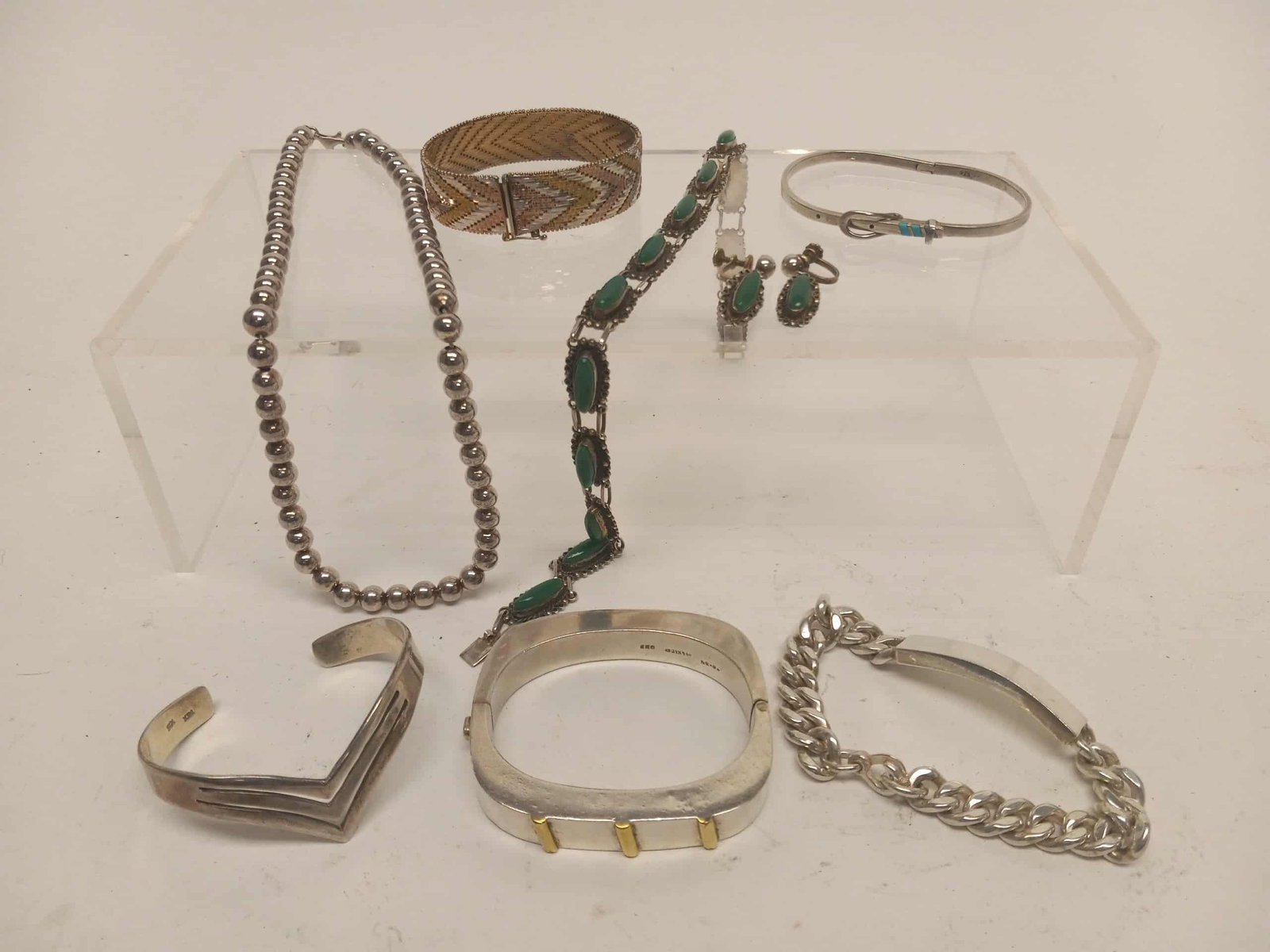 Group of Sterling Jewelry with Spratling: Group of sterling silver jewelry. All stamped sterling or 925. Spratling sweetheart bracelet, strand of sterling beads, Set of earrings with matching necklace, belt-form bracelet, two cuffs, vermeil b