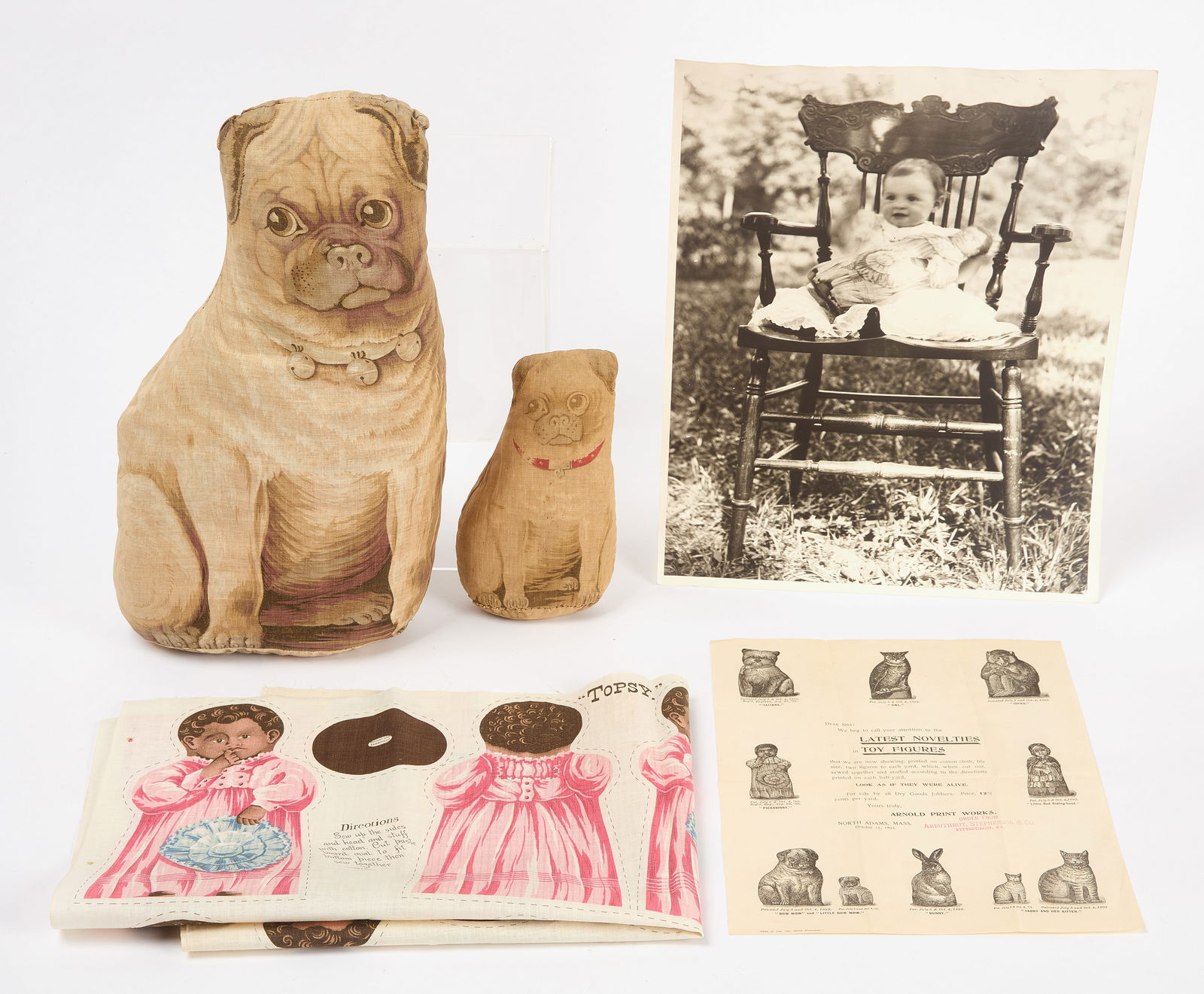 Arnold Print Works - Print Cloth Dolls and Doll Sheet: Two stuffed, printed cloth pug dogs and one print cloth doll sheet from the Arnold Print Works of North Adams, Mass. Dogs identified as the manufacturer's "Bow Wow" and "Little Bow Wow" and doll ident
