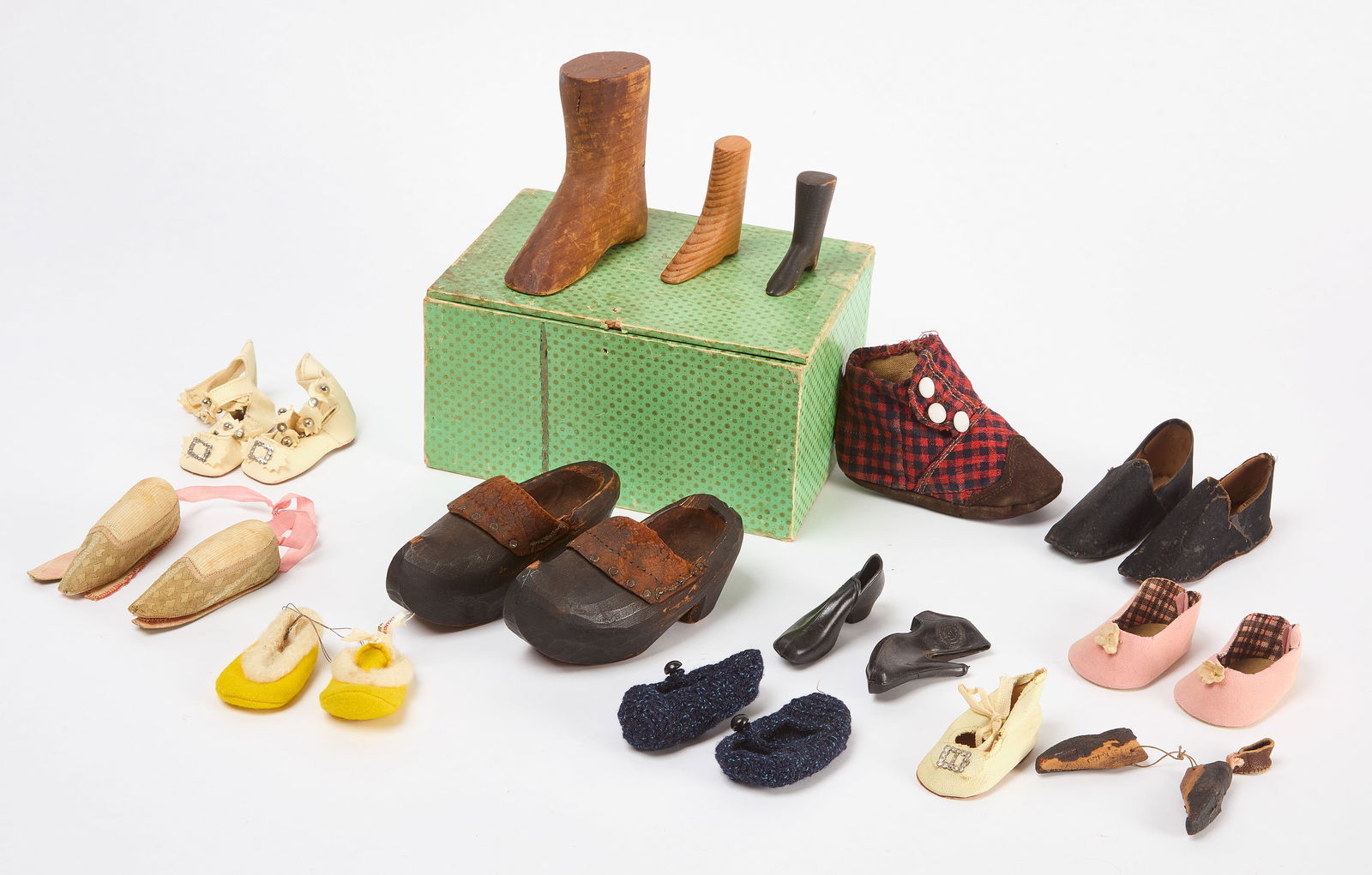 Group of Doll and Children Shoes: Group of doll and children shoes, total of 22 pieces. Smallest pair of wooden shoes inscribed '1830 Ruffer's'. Comprised of various materials and fabrics, including leather, silk, rubber, and wood. Eu