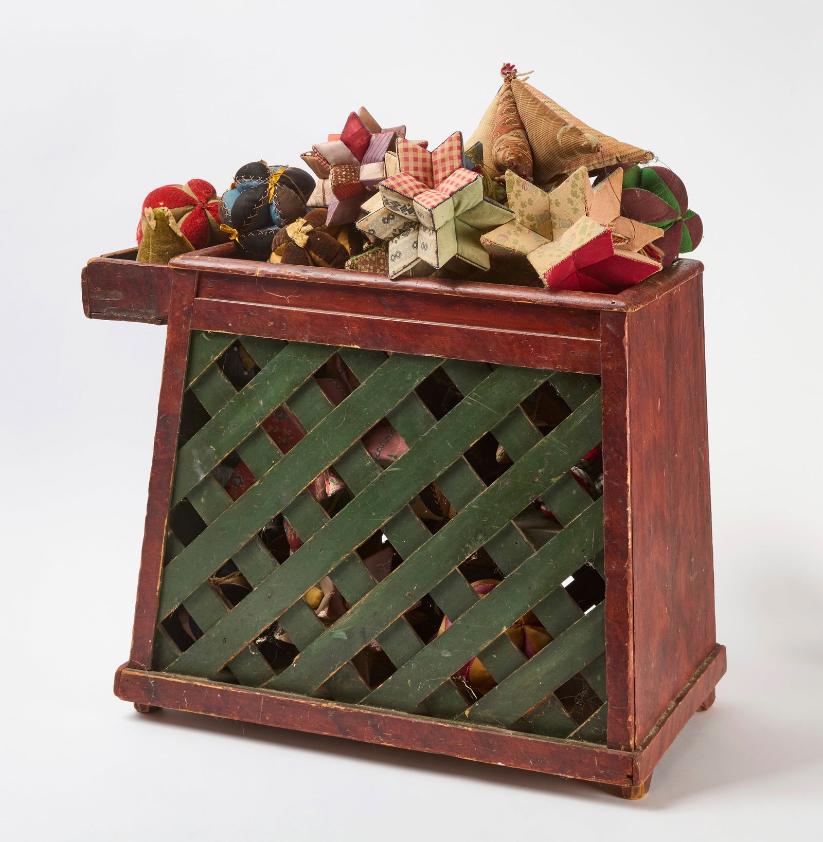 Baby Tender with Collection of Pin Cushions: Painted baby or child tender with a collection of antique pin cushions. American, late 19th century. H 18-1/2 in. W 13-3/4 in. D 21-3/4 in. 