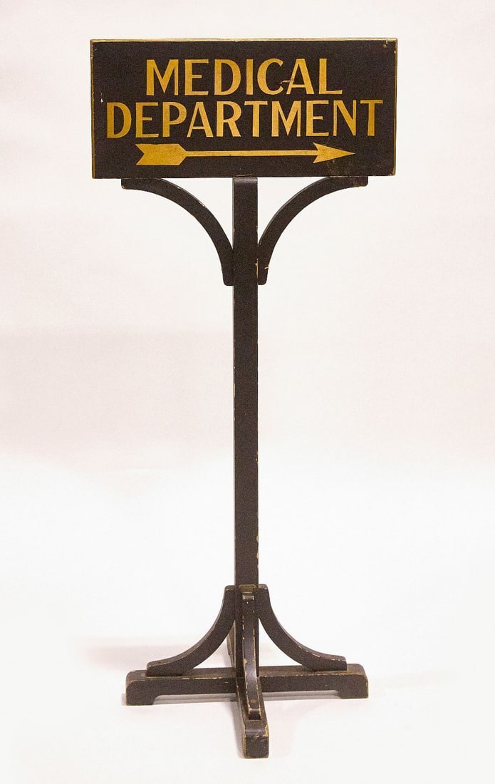 Medical Department Sign: Medical department sign with pointing arrow. Double-sided painted wood on chamfered edge board, on original stand. American, circa 1925. H 49 in. W 22 in. Sign only: H 10 in. W 22 in.
