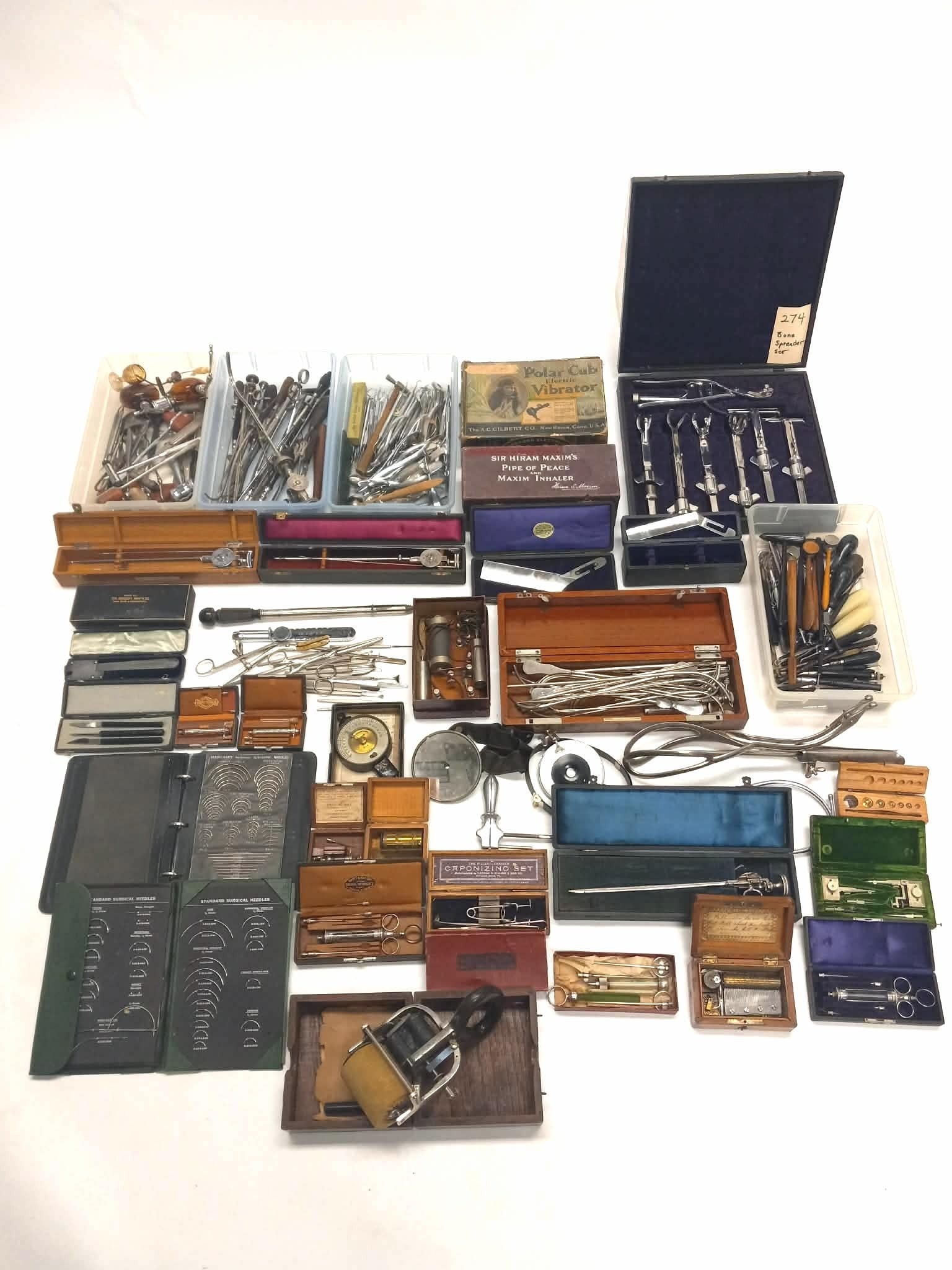 Collection of Surgical Tools: Collection of surgical and medical, and dental tools, including but not limited to forceps, trocars, books of surgical needles, a bone spreader set, 'Sir Hiram Maxim's Pipe of Peace and Maxim