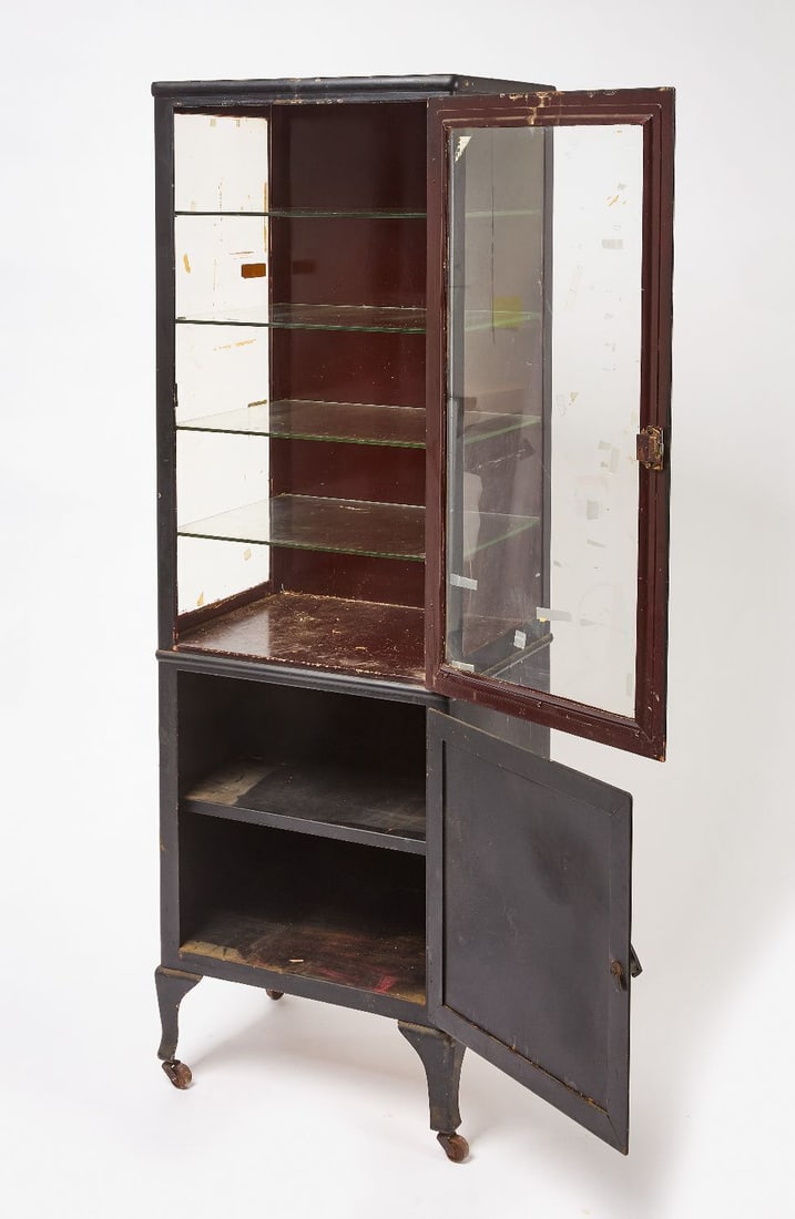 Medical Cabinet: Medical cabinet in old black paint. Steel with Glass on 3 sides. Castor wheels. American, circa 1930.H 62-1/4 in. W 20 in. D 15 in.