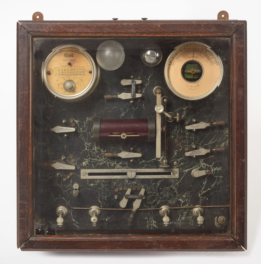 Victor Electric Co. Medical Device: Victor Electric Co. (Chicago) patent circa 1910 medical device with engraved hardware. Beveled glass, wood case. H 11 in. W 19-1/4 in. D 19-1/8 in.