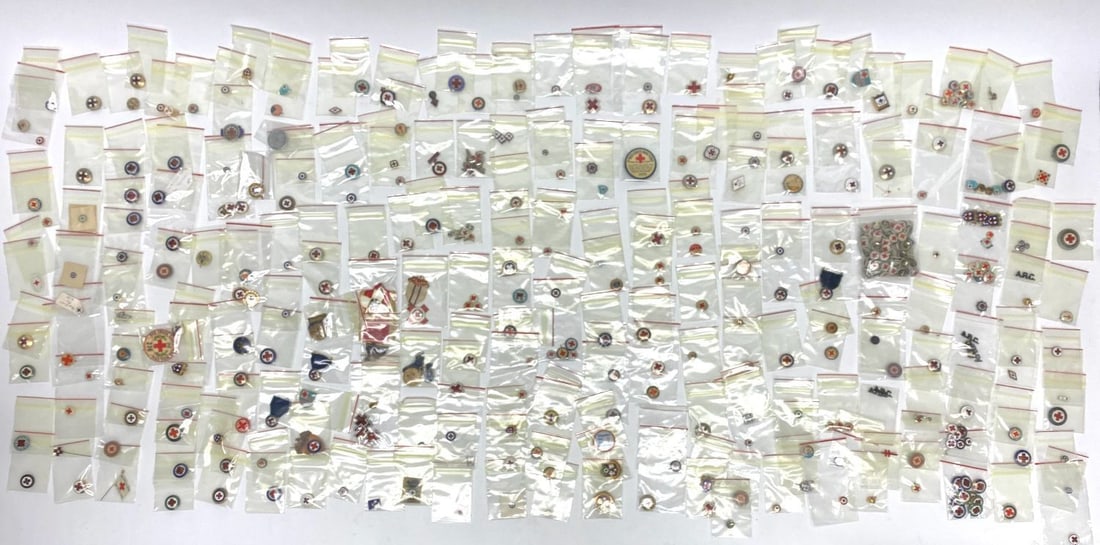 Large Group of Vintage Red Cross Pins with Sterling Examples: Large group of vintage Red Cross pins and several service award medals commemorating volunteer services and WWI relief efforts. Total of 250+ pieces. Various materials including celluloid, base