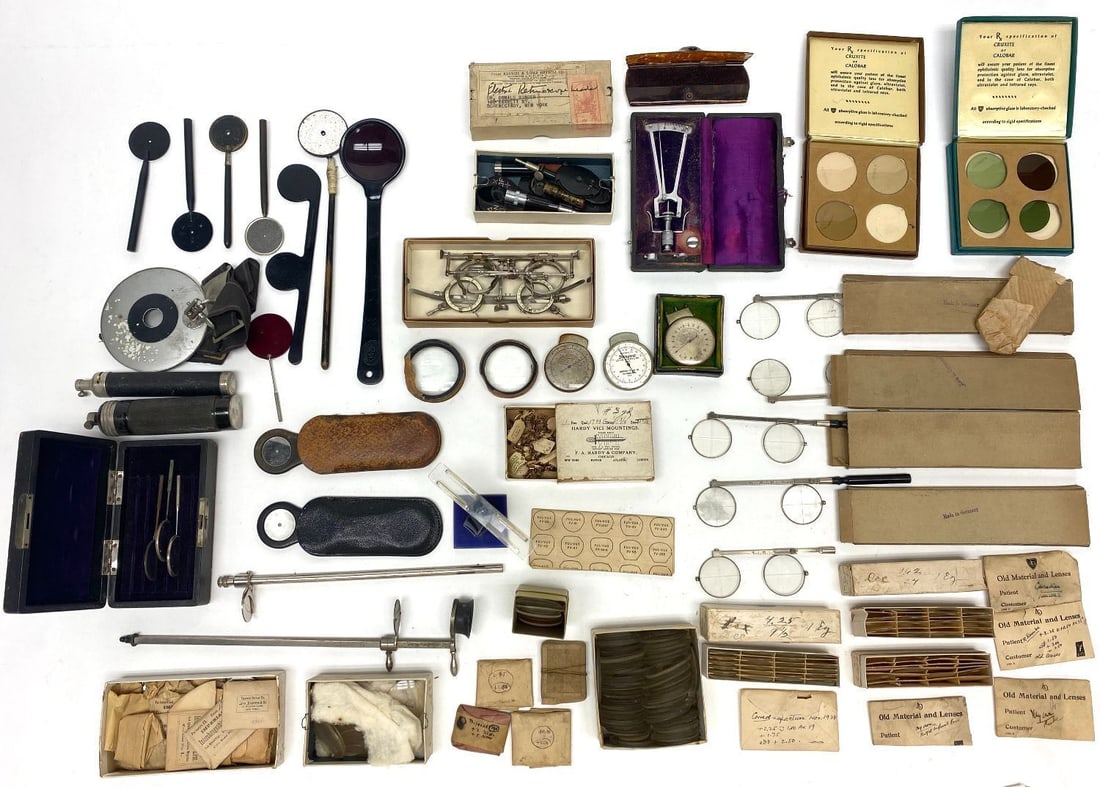 Group of Antique Optometry Items: Mixed group of vintage and antique optometry items. Includes retinoscope equipment and leads, lens measurement devices, trial frames, absorptive lens kits, and a Professor Schioetzs Tonometer.