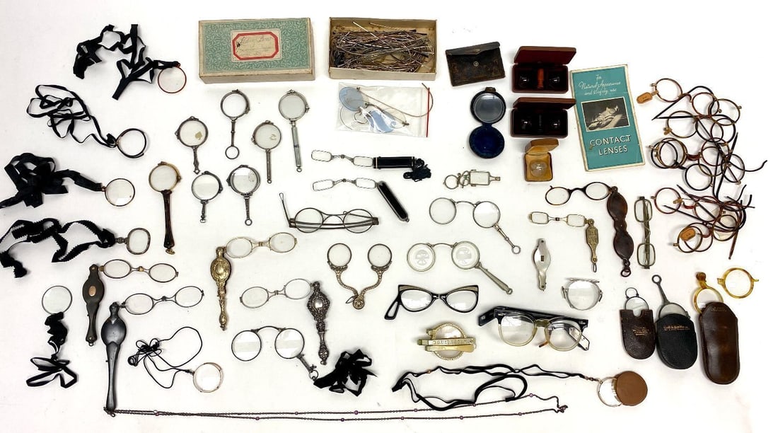 Large Group of Antique Eyewear: Large group of antique eyewear. Assortment includes: lorgnettes, monocles, pince-nez, a group of frame rims and temples, vintage eye contacts, and mid-century reading glasses including one vintage pai