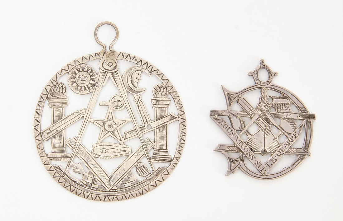 Two Early English Masonic Medallions: Two early English Masonic medallions with openwork. Likely coin silver. Larger medal depicts the compass and square with celestial imagery and columns. circa 1830. D 2-1/4 in. and D 1-1/2 in.