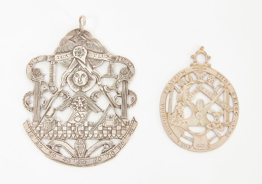 Two English Masonic Medallions: Two English Masonic medallions with openwork. Likely coin silver. circa 1830. H 2-1/2 in. W 2 in., and H 1-7/8 in. W 1-3/8 in.