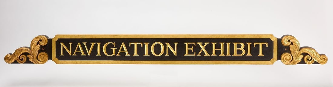 Navigation Exhibit Sign: 'Navigation Exhibit' sign. High quality single-sided carved and painted wood. Signed on reverse F. Klotz. American, Mid 20th centuryH 6-1/2 in. L 71-1/4 in.