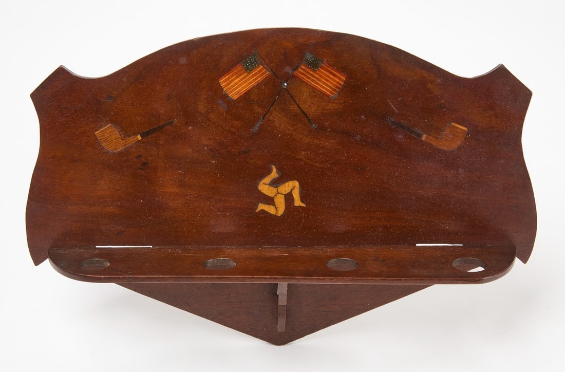 POW Patriotic Pipe Holder with Trinacria: Prisoner-of-War pipe holder with crossed US flags and the 3-legged Sicilian symbol 'Trinacria'. Marquertry and stained wood. Inscribed on reverse POW 5728. Can hold 4 pipes.H 8 in. W 12-1/4