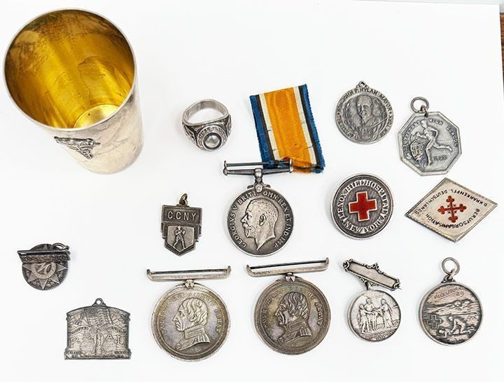 Group of Silver Medals: Group of silver medals. Including a 1928 lifesaving medal marked sterling), 1886 Greenwich Hospital School good conduct medal and a second undated example (acid tested), 1922 Styvesant High School