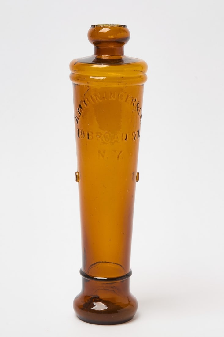 A. M. Bininger & Co Figural Cannon Whiskey Bottle: A. M. Bininger & Co (19 Broad St. New York) molded amber glass figural whiskey bottle in cannon shape. H 12-1/2 in.