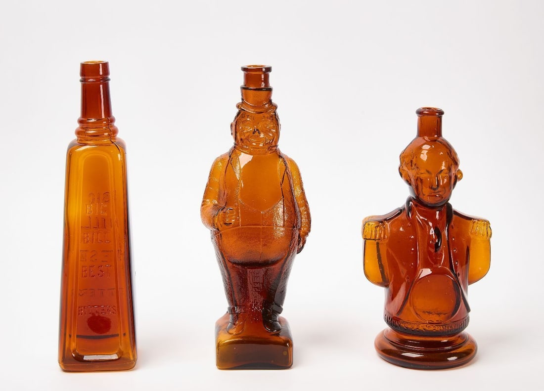 Two Big Bill Best Bitters Bottles, and Simon's Centennial Bitters Bottle: Two Big Bill Best Bitters bottles. Both in molded amber glass. 19th century. H 11-3/4 in. and H 12 in. Together with Simon's Centennial Bitters bottle in the form of George Washington. Molded