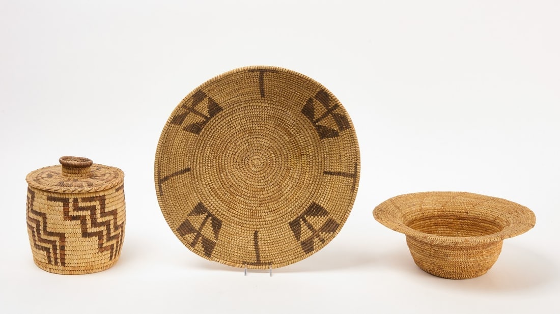 Three Native Baskets: Three baskets including a covered Papago example. Mission and a Pima hat. Early 20th century.Hat: D 12-1/4 in. Covered basket: H 8 in. D 7 in. Bowl: H 3-1/2 in. D 15 in.