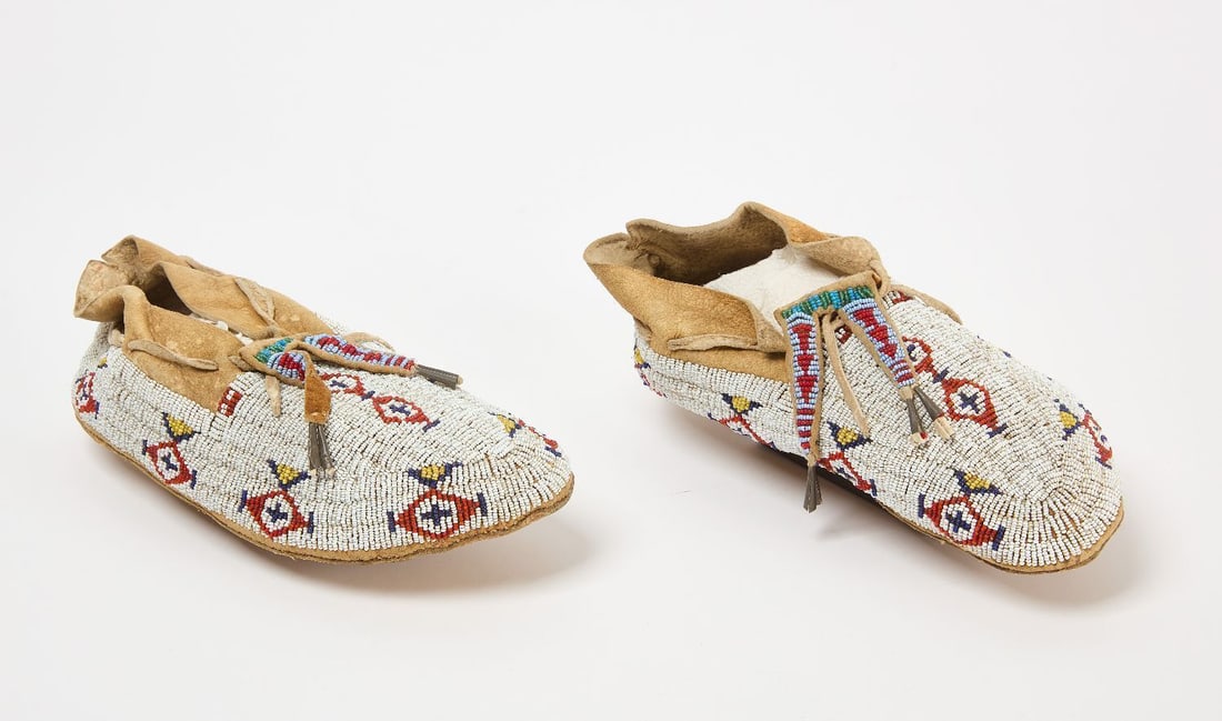 Pair of Beaded Moccasins: Pair of beaded moccasins. Glass beads on hide. Plains region, circa 1890.L 10-1/4 in.