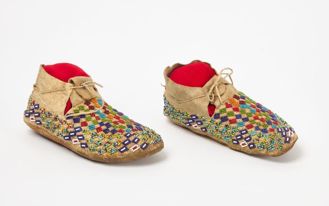 Pair of Beaded Moccasins: Pair of beaded Native Moccasins. Beadwork on hide. Sinew sewn. Plains region. Early 20th century. L 9 in.