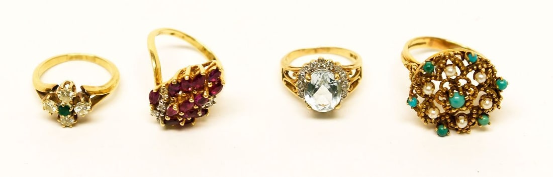Four 14k Gold Rings: Four 14k gold rings. Size 6 with rubies and diamonds, size 8.5 with jade pearls and seeded pearls, size 5.5 with four diamonds surrounding central emerald, and size 5 with central aquamarine and