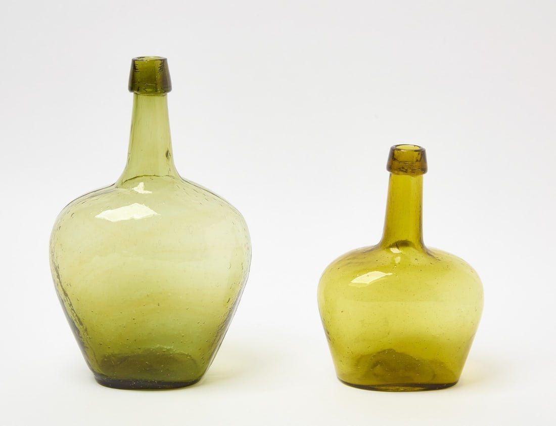 Two Miniature Demijohn Bottles: Two miniature green glass demijohn bottles with pontil bases. American, late 18th-early 19th century.H 11-3/4 in. and H 8-1/4 in. 