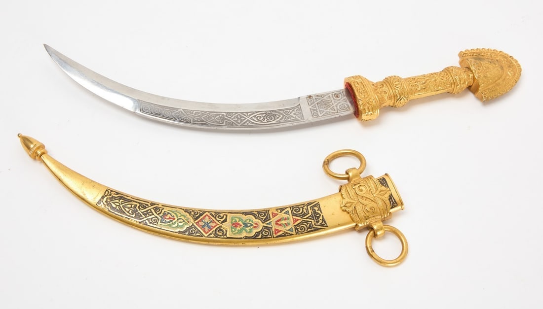 Gilt-Sheathed Curved Dagger: Curved dagger in a gilt metal sheath. Toledo, Spain, circa 1950. Overall: L 14-1/4 in. Blade only: L 8 in.