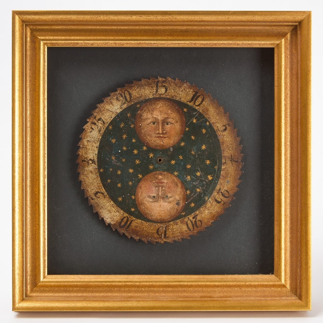 Celestial Painted Serrated Edge Moon Phase Dial: Painted moon phase clock dial with serrated edge. Two moons and stars are painted in the center. Professionally framed. Frame: H 13-3/8 in. W 13-1/2 in.Dial: D 7-1/2 in.
