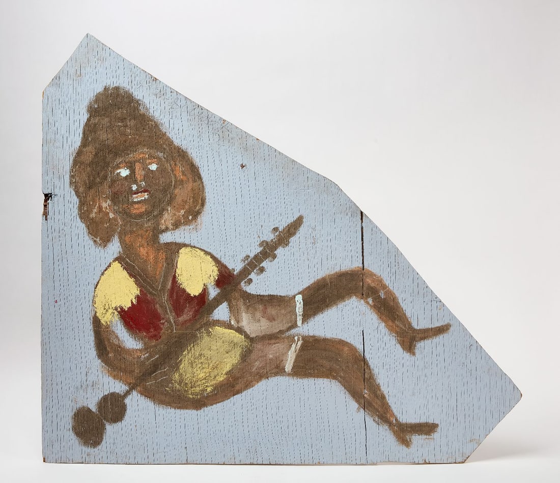 Jimmie Lee Sudduth - Figure with Instrument on Board: Jimmie Lee Sudduth (1910–2007, was active/lived in Alabama, also known as Jimmy), painting of a figure with a musical instrument. Paint, mud and clay on found wood board. Signed top center.