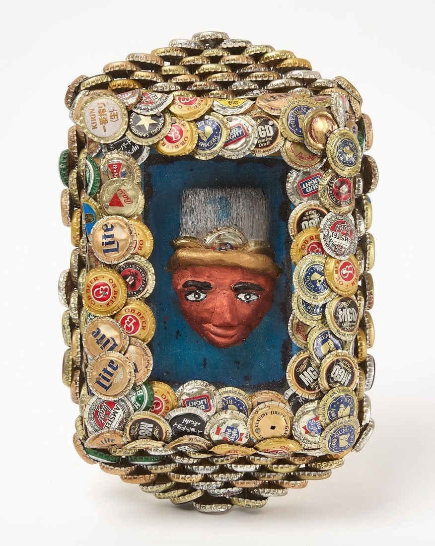 Mr. Imagination - Self Portrait in Bottle Cap Frame: Mr. Imagination (1948–2012), Self portrait in bottle cap frame. Untitled mixed media, clay, bottle caps, paint brush bristles, and found objects. H 13-3/4 in. W 8-3/4 in. D 3 in.