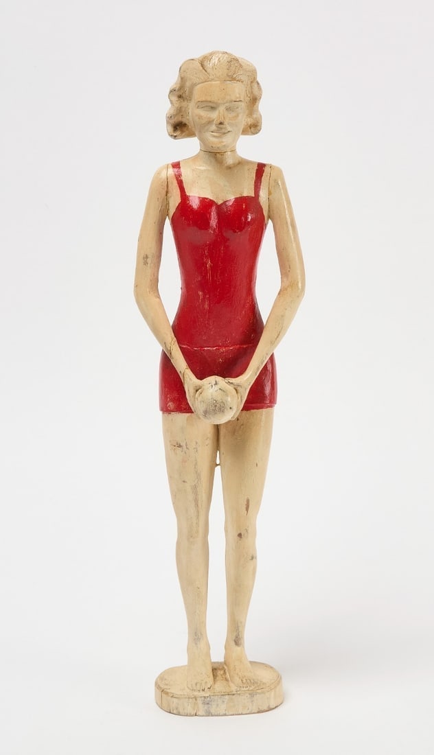 Folk Art Figure of a Woman: Folk art figure of a woman in a red swimsuit. Carved wood with original paint. Ameircan, circa 1930.H 17-3/4 im.