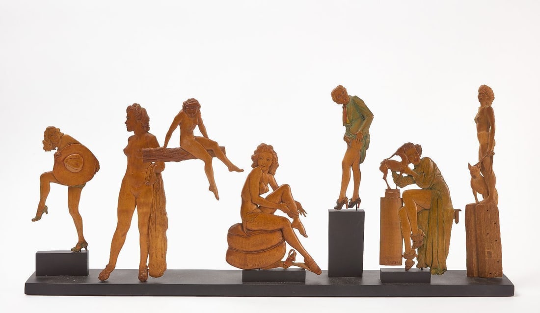 Seven Carved and Painted Pin-up Figures: Seven carved and painted pin-up figures all mounted to display base. Partially nude pin-up figures, ranging in various sizes, poses and outfits. One figure is fixed to another figure to be suspended.