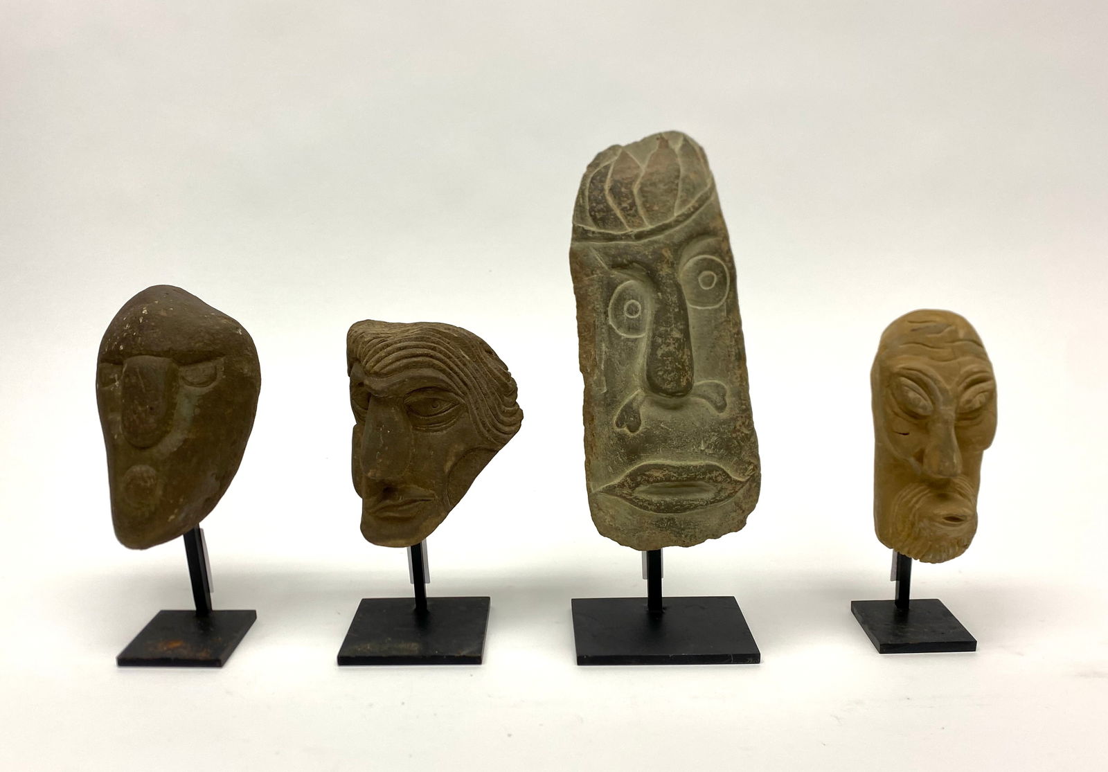 David George Marshall - Four Stone Heads: David George Marshall (New York, b. 1936), group of four stone heads. Stands included. American, 20th century.Height without stands, smallest to largest: H 5-1/8 in. H 5-1/4 in. H 6-1/2 in. H 9-1/4 in