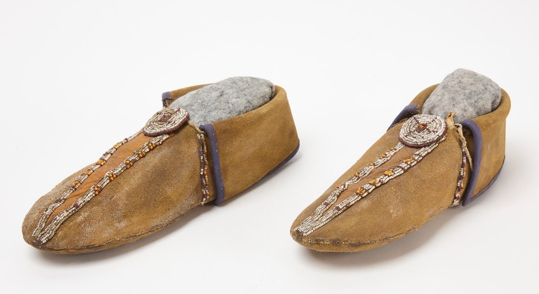 Pair of Beaded Moccasins: Pair of early beaded moccasins. Glass beadwork on hide with yellow pigment. 19th century.L 10-1/2 in