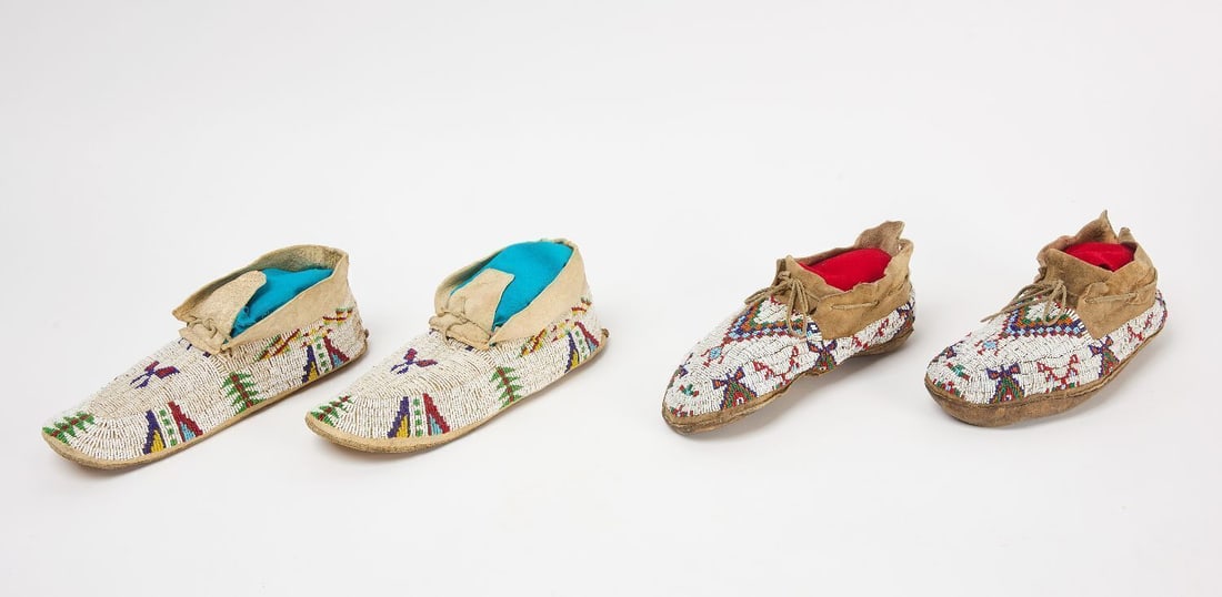 Two Pairs of Beaded Moccasins: Two pairs of beaded moccasins. Glass beads on hide.Early 20th century.L 10-1/2 in and 11 in.