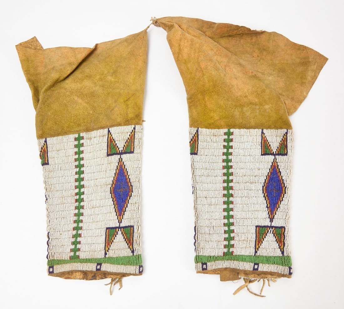 Pair of Native Beaded Leggings: Pair of Cheyenne beaded leggings. Glass beads of yellow pigmented hide. Plains region, circa 1890.L each: 16 in.