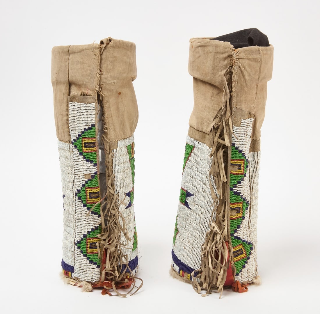 Pair of Beaded Leggings: Pair of Cheyenne leggings with fringe. Glass beads on hide with red painted cuffs. Sinew sewn. Plains region, circa 1895.L 14-1/2 in.