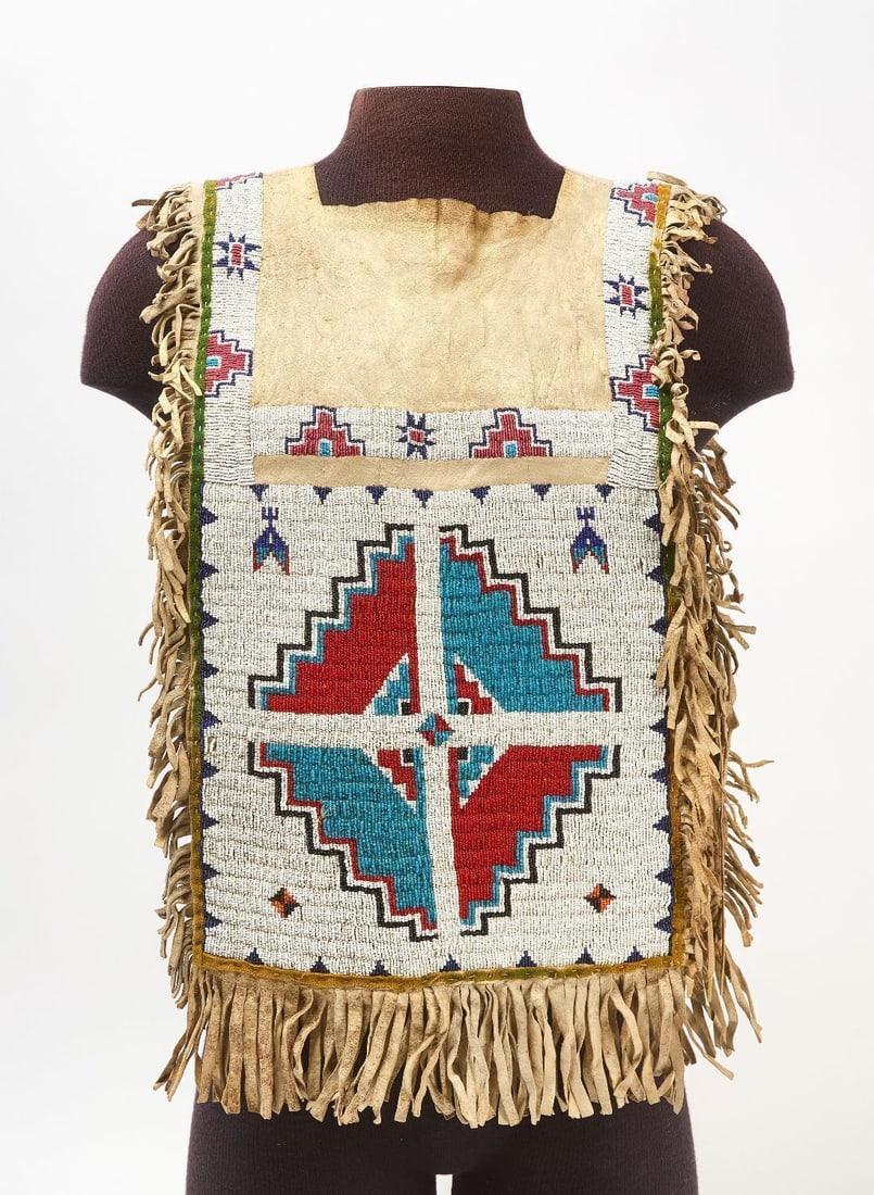 Sioux Shirt Bag: Sioux beaded hide shirt bag with geometric patterns and fringe, circa 1900.L 28 in. W 17 in.