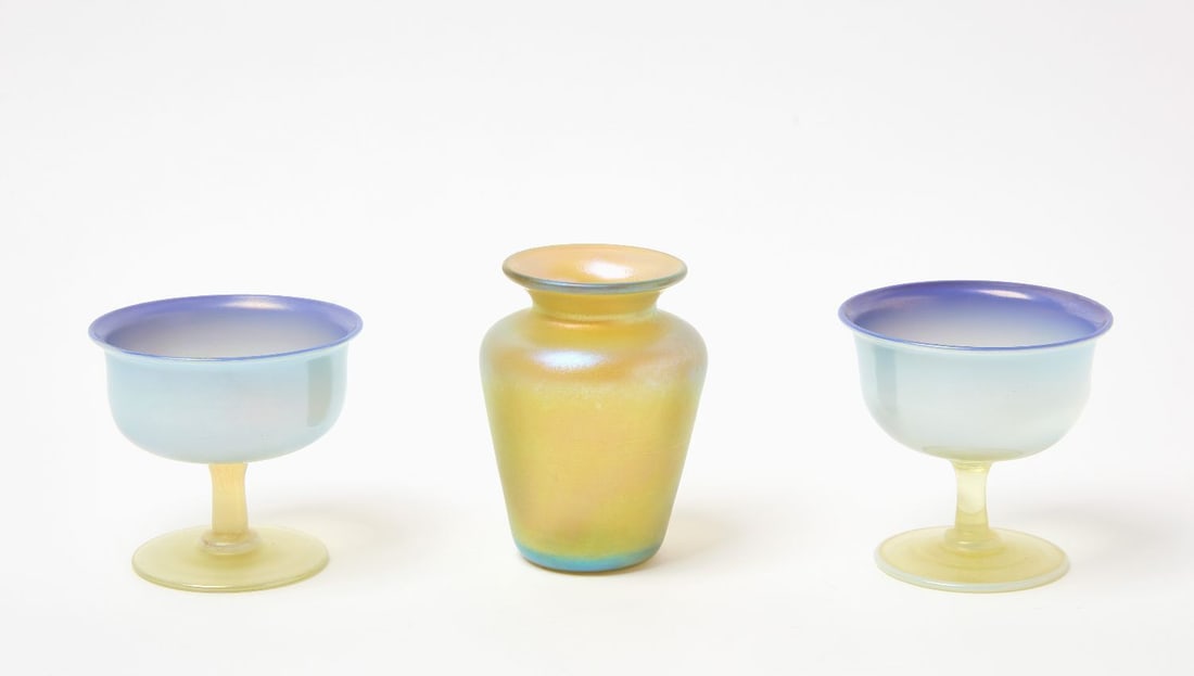 Tiffany Favrile Glass Stemmed Dessert Cups and Vase: Two Tiffany Favrile Studios stemed dessert cups together with a Tiffany Studios Favrile vase. Cups marked 'L.C.T Favrile' with numbers to underside, and vase marked 'L.C.Tiffany Favrile