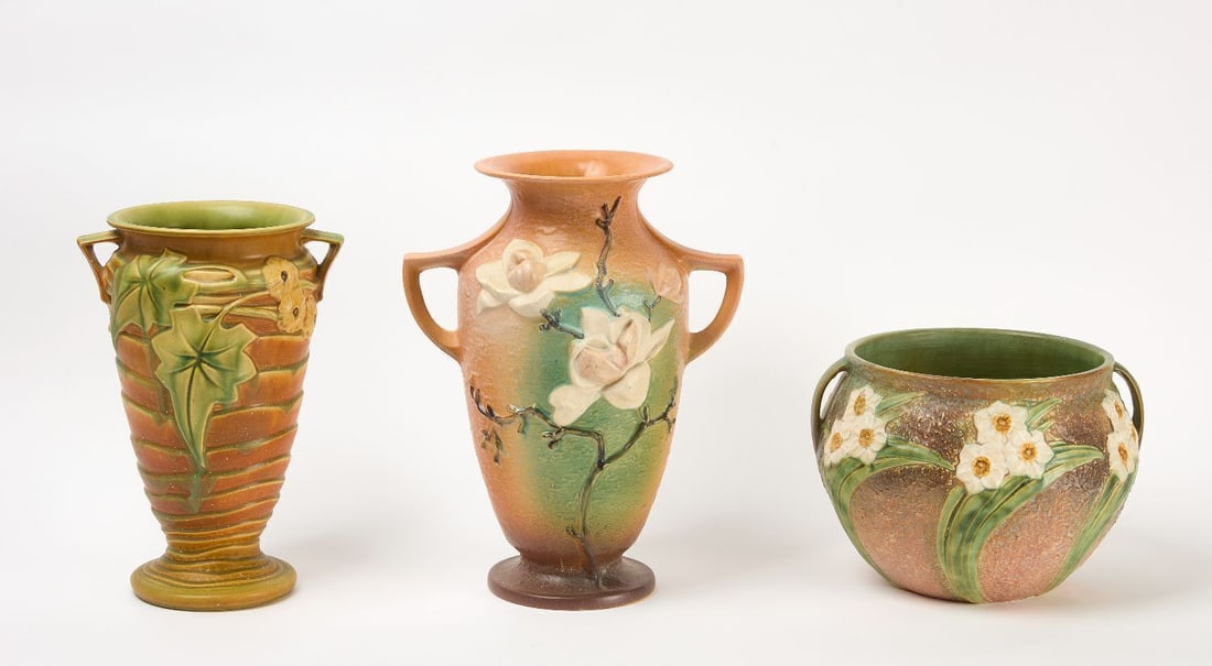 Three Roseville Pottery Vases: Three roseville pottery vases with flowers. Circa 1940.H 9 in. D 10 in.H 14-1/4 in. D 7-5/8 in.H 16-1/4 in. D 7-1/2 in.