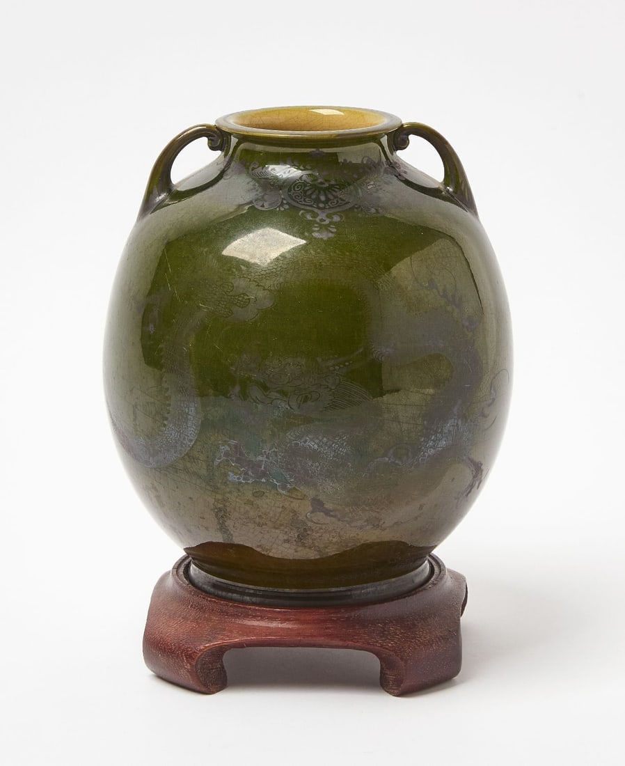 Green Glazed Art Pottery Vase with Dragons: Art pottery vase with green glaze and dragons. Makers stamp on bottom. Wood stand included as shown. H 7-3/4 in.