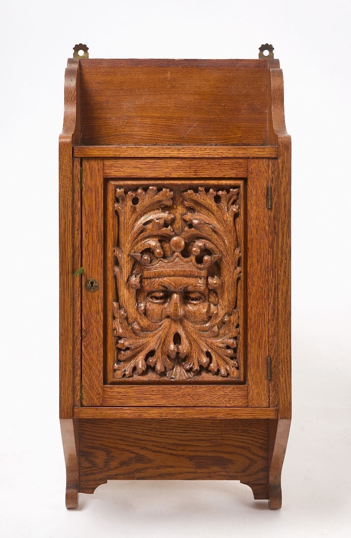 Relief Carved Hanging Cupboard: Relief-carved hanging cupboard. Door with portrait of a King. European, circa 1920. H 28 in. W 13-1/4 in. D 7-1/2 in.
