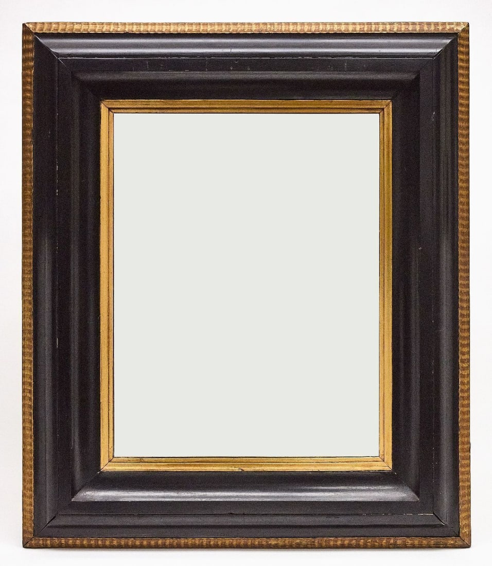 Large Wood-Framed Mirror: A large wood-framed mirror. Black and gold painted wood. American, 20th century.H 40-1/2 in. W 34-1/2 in. D 2-1/2 in. 