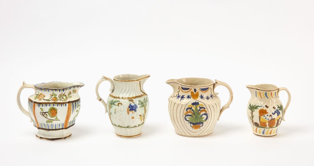 Four Pearlware Pitchers: Four pearlware ceramic pitchers. American Eagle, (2) Groom Carousing and Striped jug. English, circa 1800. H 5 in-6 in.