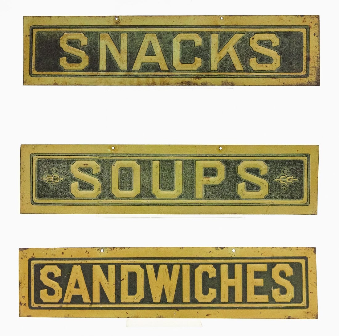 Three Embossed Diner Signs: Three embossed diner signs. 'Snacks', 'Soups', and 'Lunches'. Embossed tin with original paint. American, circa 1920. Each: L 3-1/4 in. W 13-7/8 in.